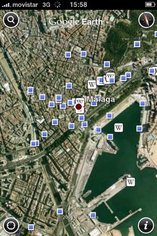 Google Earth localizandome en Málaga. Podemos ver los íconos de la Wikipedia y los puntos azules que indican que hay fotos de Panoramio.